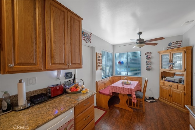 dining area featuring ceiling fan and dark hardwood / wood-style flooring