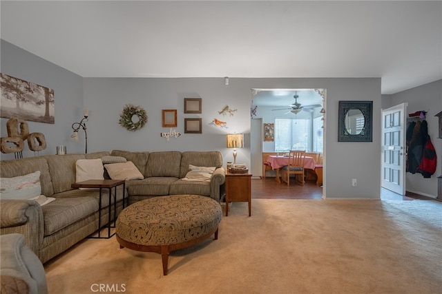 living room featuring carpet flooring and ceiling fan