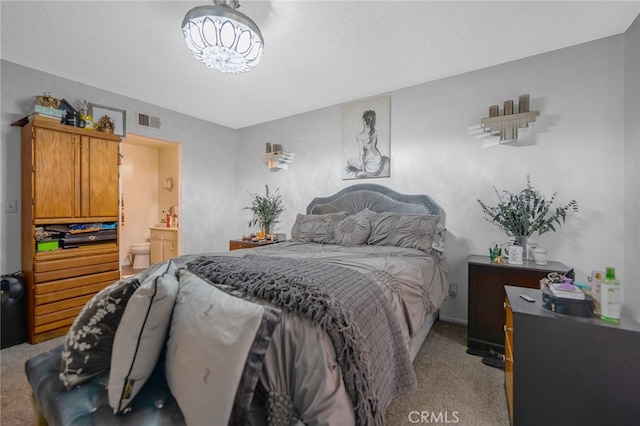 carpeted bedroom featuring connected bathroom