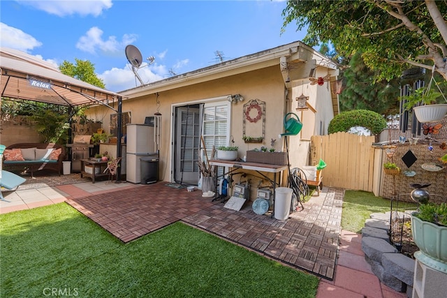 rear view of property featuring a yard and a patio