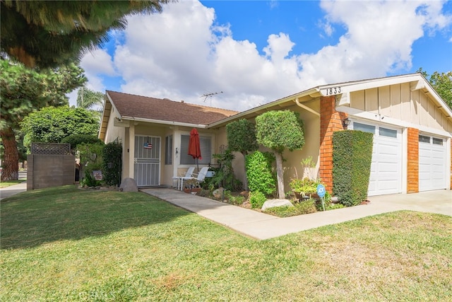 view of front of home with a garage and a front lawn