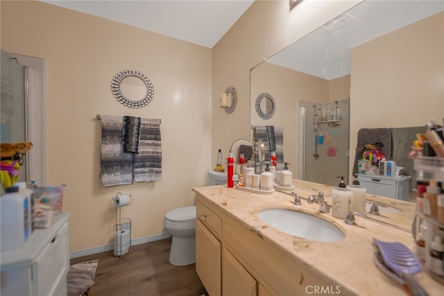 bathroom with a shower with door, hardwood / wood-style flooring, vanity, and toilet