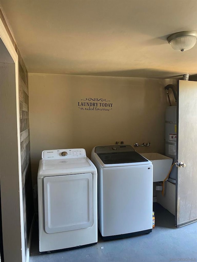 laundry area featuring secured water heater, sink, and washing machine and clothes dryer