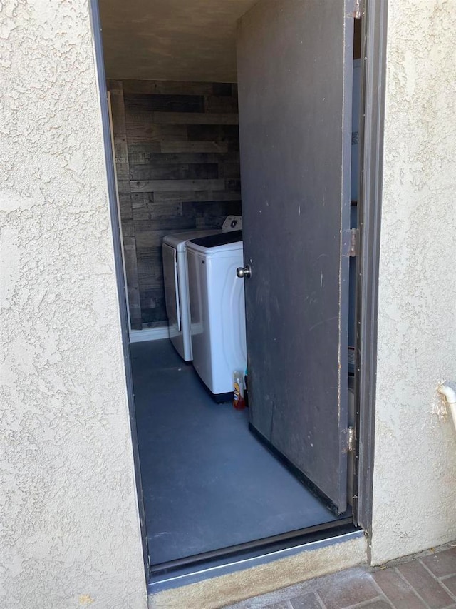 view of exterior entry featuring separate washer and dryer