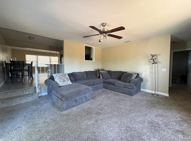 living room with ceiling fan and carpet