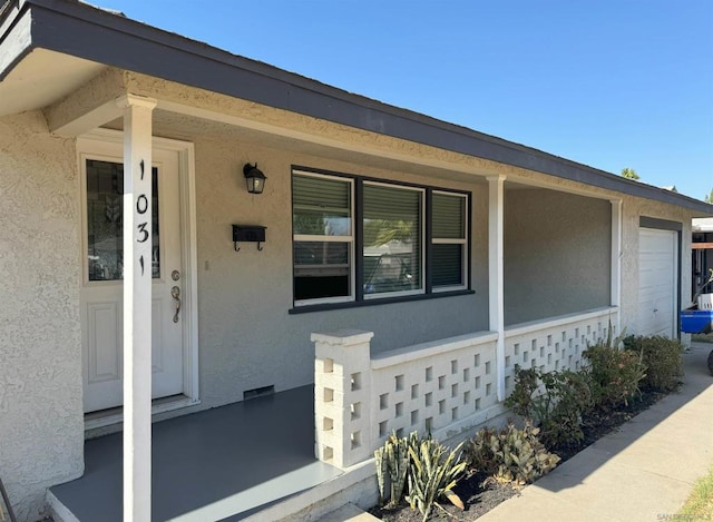 view of exterior entry with a garage