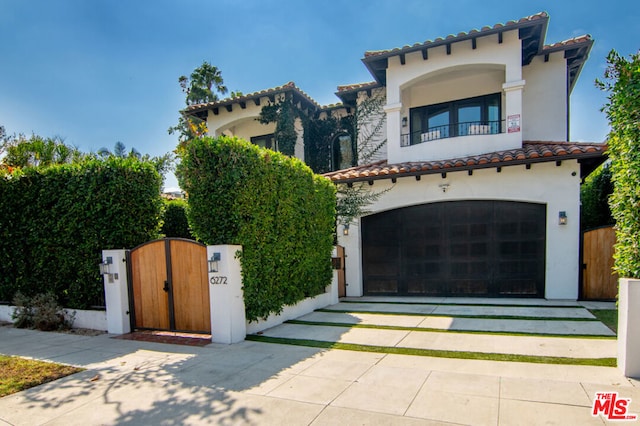 mediterranean / spanish-style home featuring a balcony and a garage