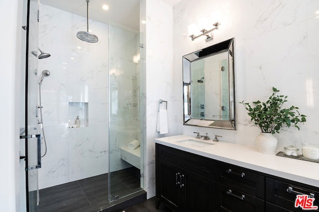 bathroom featuring vanity and a shower with shower door