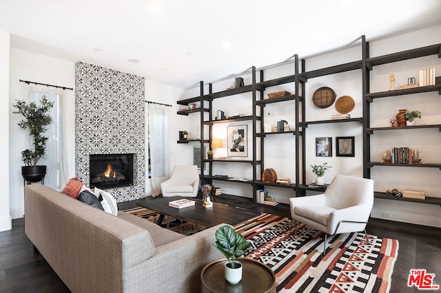 living room featuring dark hardwood / wood-style flooring and a fireplace