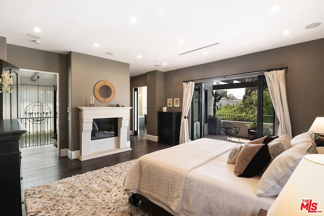 bedroom with access to exterior and dark wood-type flooring