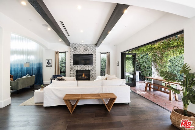 living room with beamed ceiling, dark hardwood / wood-style flooring, and a wealth of natural light