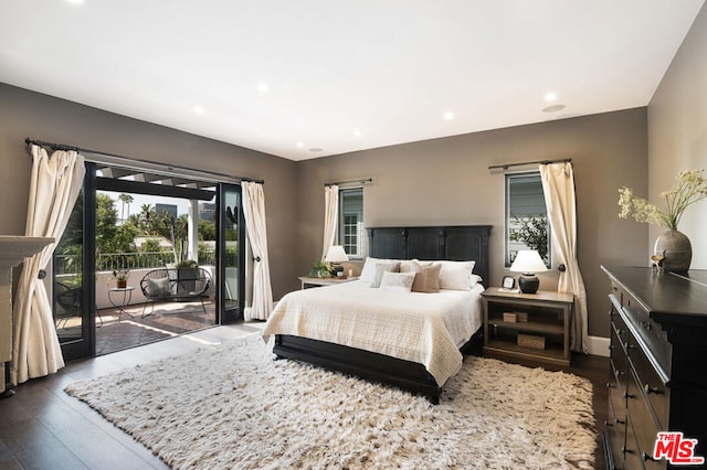 bedroom with dark hardwood / wood-style flooring and access to outside