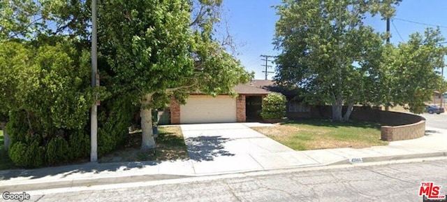 view of property hidden behind natural elements featuring a garage