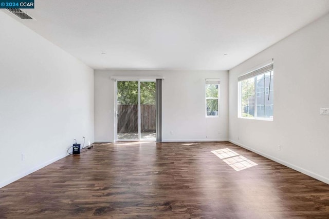 empty room with dark hardwood / wood-style flooring