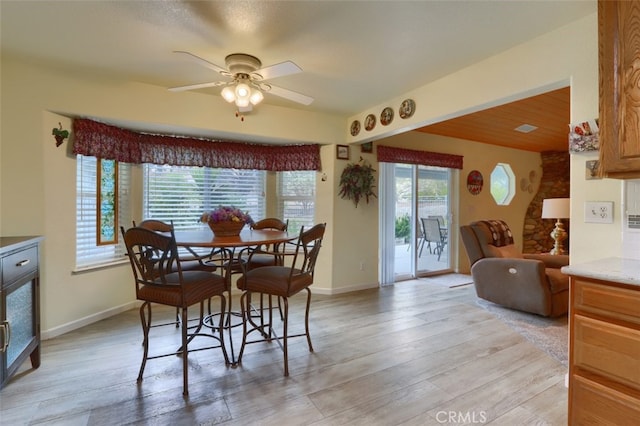 dining space featuring light hardwood / wood-style floors and ceiling fan