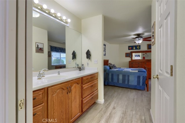 bathroom with ceiling fan, vanity, and hardwood / wood-style flooring