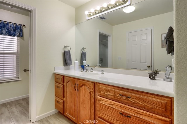 bathroom featuring hardwood / wood-style flooring and vanity