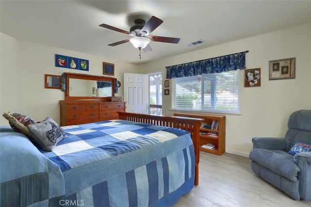 bedroom with light hardwood / wood-style flooring and ceiling fan