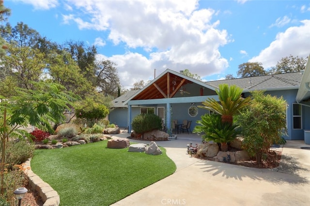 view of front of property featuring a front lawn and a patio