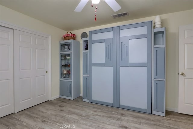 unfurnished bedroom with ceiling fan and light hardwood / wood-style floors