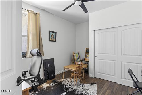 office space featuring ceiling fan and dark hardwood / wood-style flooring