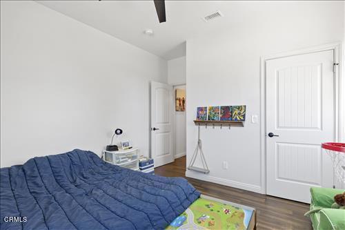 bedroom featuring ceiling fan and dark wood-type flooring