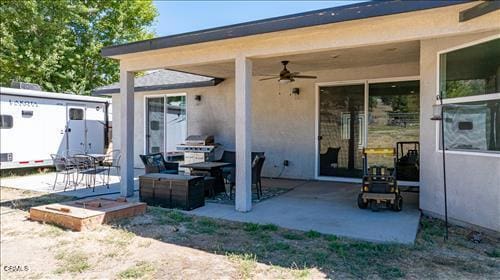 back of property with a patio and ceiling fan