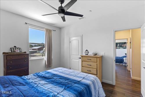 bedroom featuring ceiling fan and dark hardwood / wood-style flooring