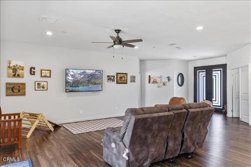 living room with ceiling fan and dark hardwood / wood-style floors