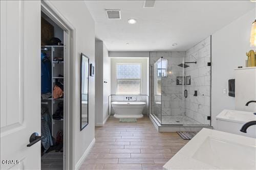 bathroom featuring shower with separate bathtub, vanity, and hardwood / wood-style floors