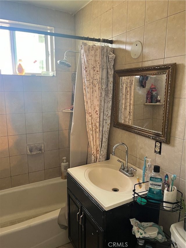 full bathroom with shower / bath combination with curtain, vanity, tile walls, and toilet