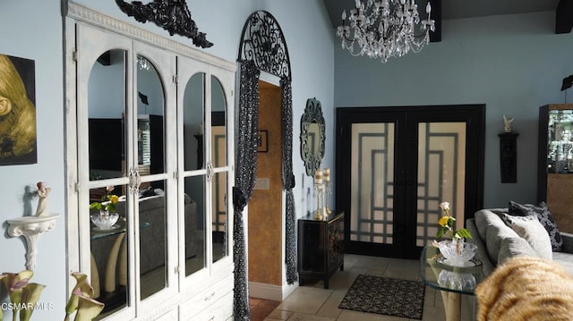 entryway with french doors, light tile patterned floors, and a notable chandelier