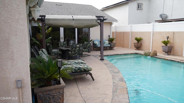 view of pool with an outdoor living space and a patio