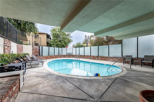 view of swimming pool with a patio