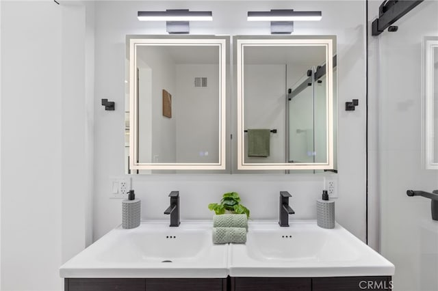 bathroom featuring vanity and a shower with shower door