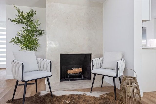 sitting room featuring hardwood / wood-style floors and a fireplace