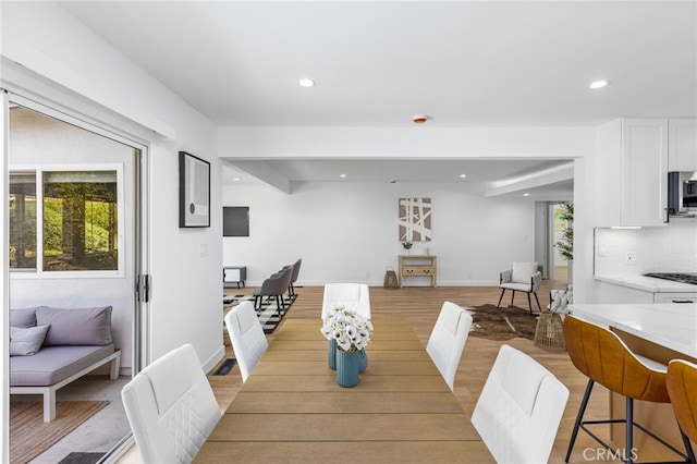 dining space featuring plenty of natural light and light hardwood / wood-style flooring