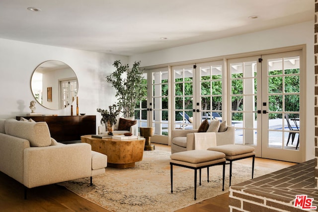 living room with french doors and hardwood / wood-style flooring