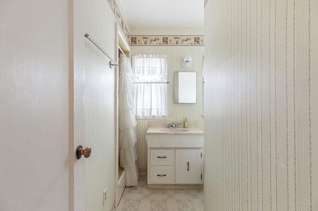 bathroom featuring vanity and  shower combination