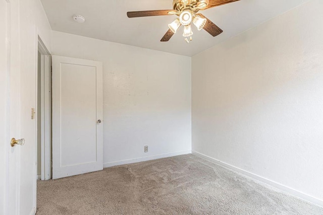 empty room featuring light carpet and ceiling fan