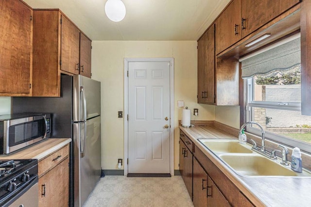 kitchen with stainless steel appliances, plenty of natural light, and sink