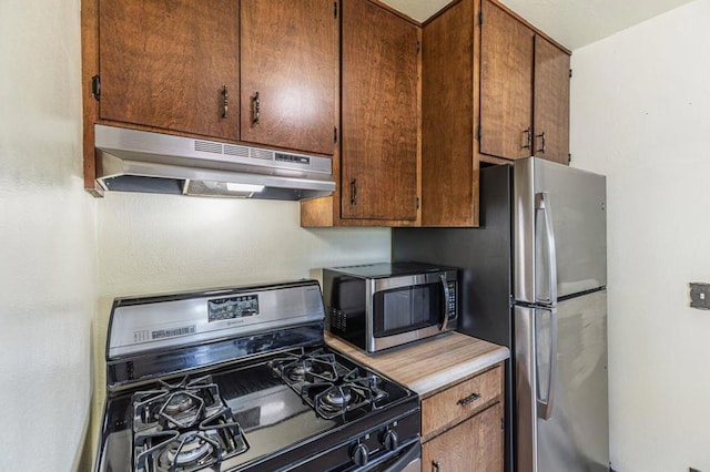 kitchen with appliances with stainless steel finishes and exhaust hood