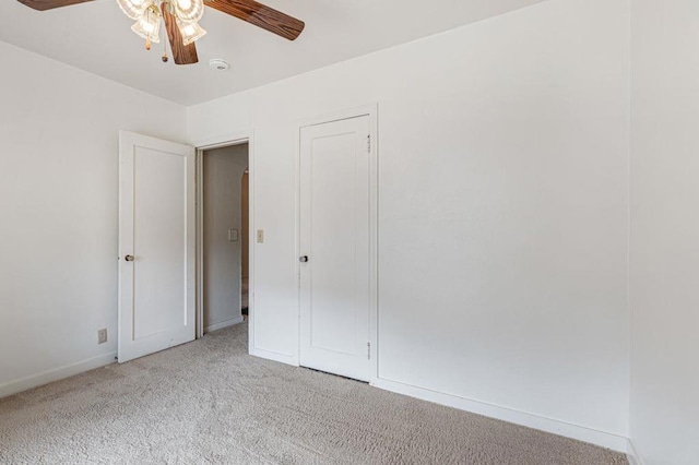 unfurnished bedroom featuring ceiling fan and light carpet