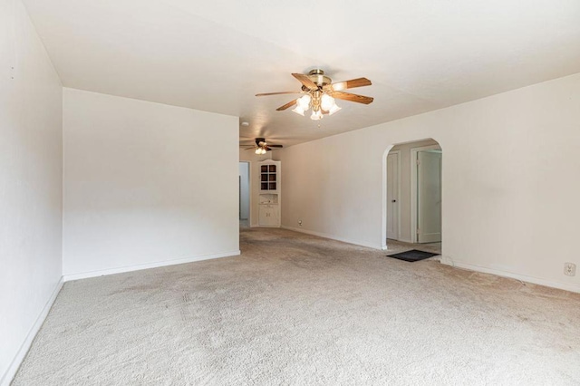 carpeted spare room with ceiling fan