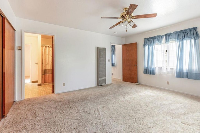 unfurnished bedroom featuring ceiling fan, light carpet, and connected bathroom