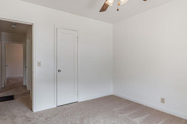 unfurnished bedroom featuring ceiling fan and light carpet