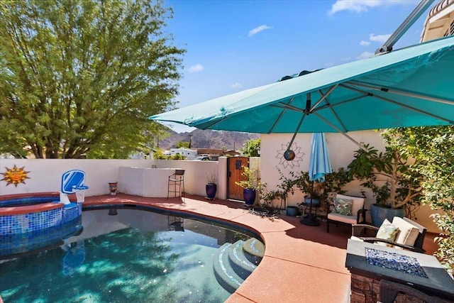 view of swimming pool featuring an in ground hot tub and a patio