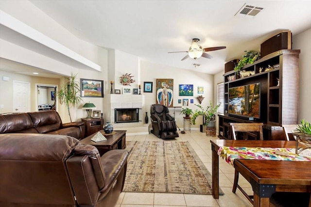 living room featuring ceiling fan, light tile patterned flooring, and lofted ceiling