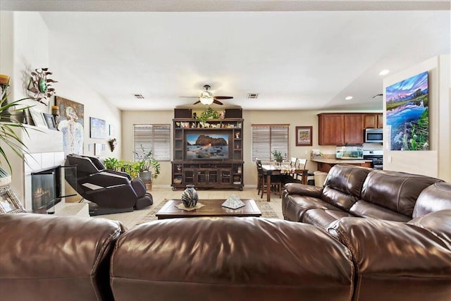 living room with ceiling fan and light tile patterned flooring