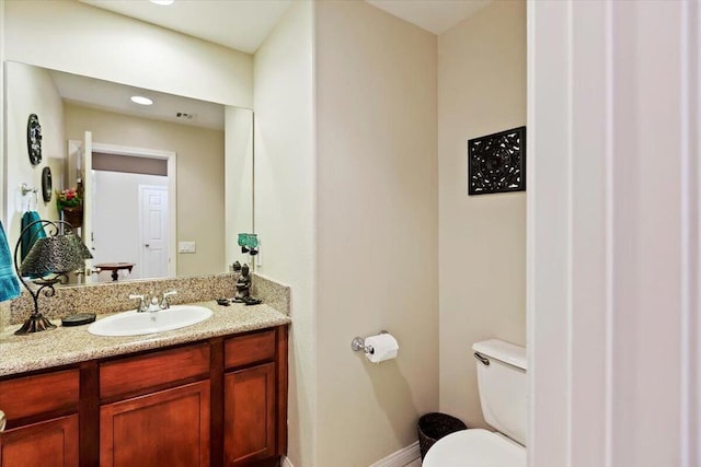 bathroom featuring vanity and toilet